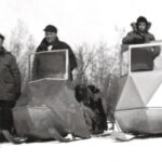 4 men on Polaris Sno-mobiles