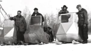 4 men on Polaris Sno-mobiles