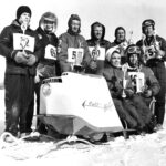 Marly and Edson Brandt seated on snowmobile Randy Hites behind